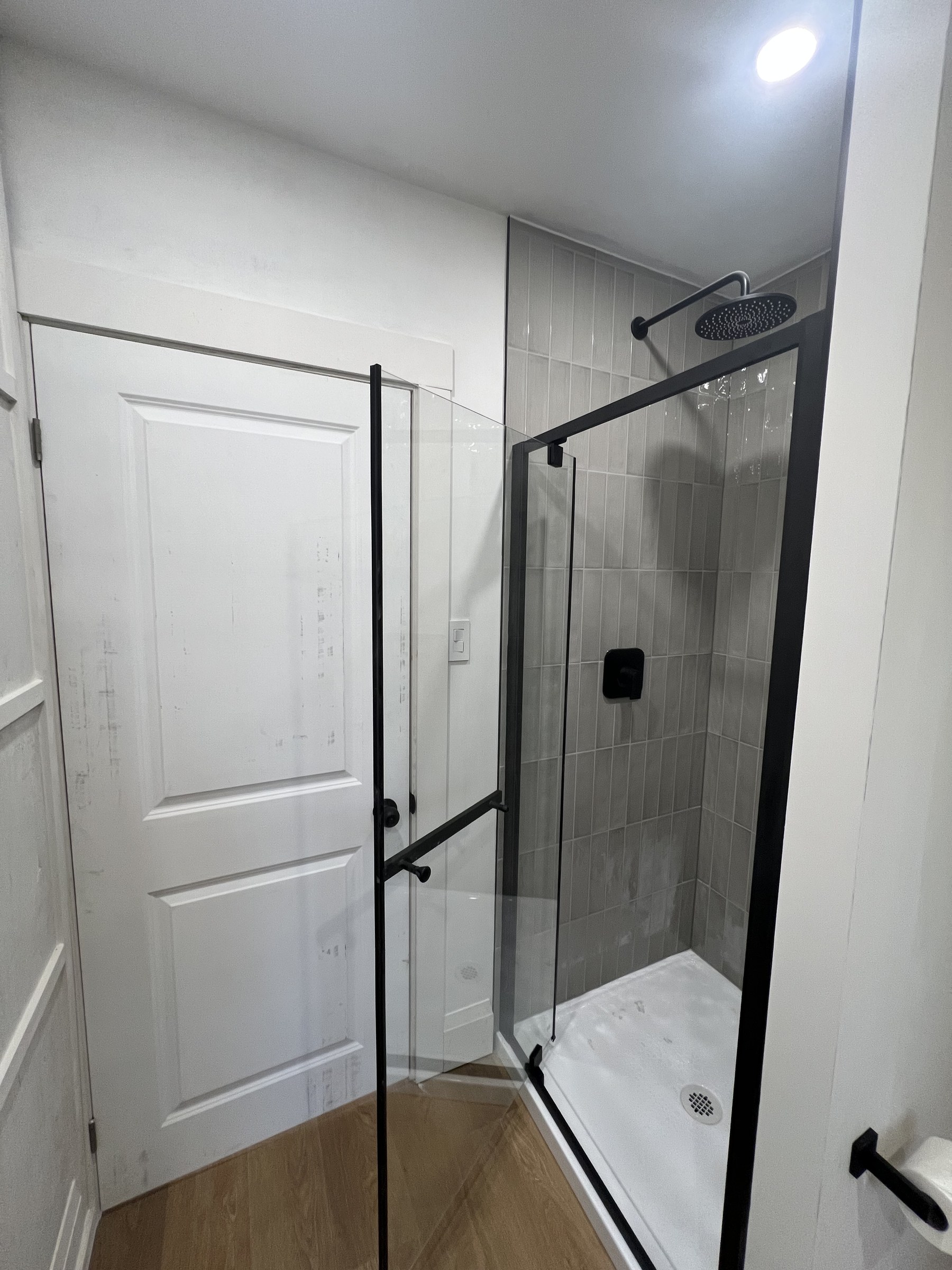 3 by 3 foot tiled glass shower with matte black hardware
